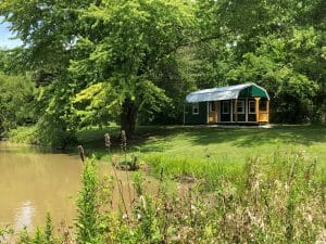 Green playhouse shed by the lake