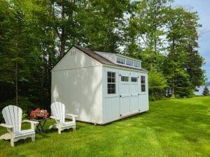 White utility shed in backyard
