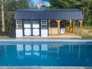 White shed with porch by pool