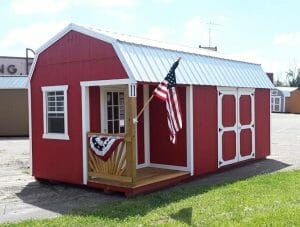 Red shed with porch holding American flag