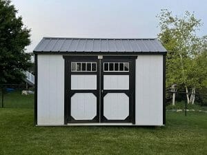 white utility shed with black roof