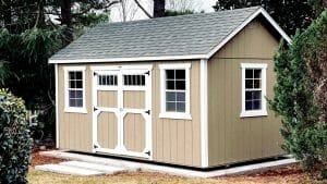 beige utility shed with black shingle roof