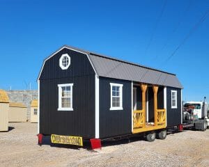 Black shed with center porch on delivery truck
