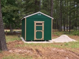 Small green shed on gravel pad
