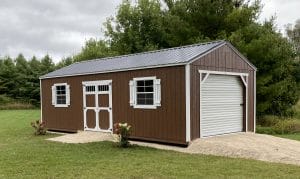 Brown storage shed with garage door